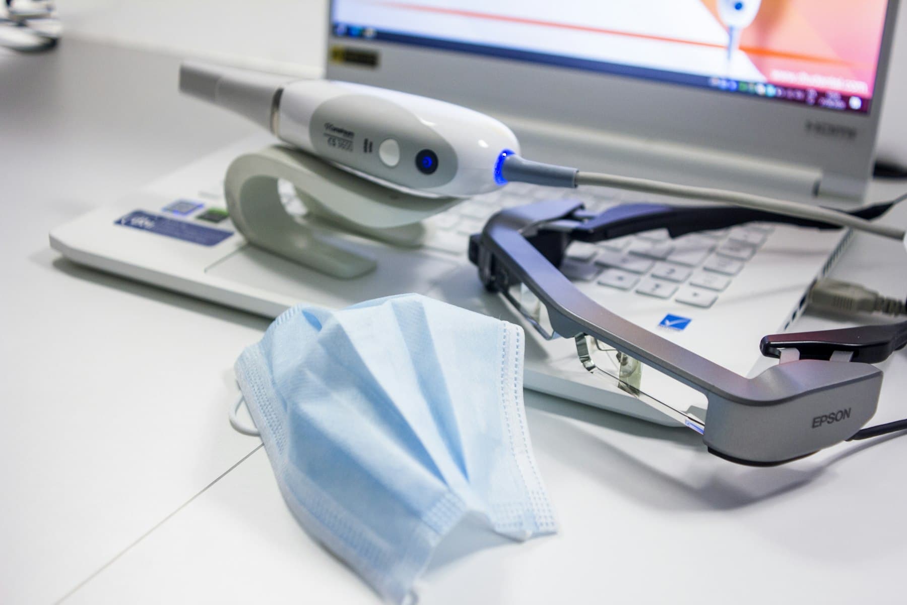 Dental technician using an intraoral scanner to capture a digital impression for Exocad design